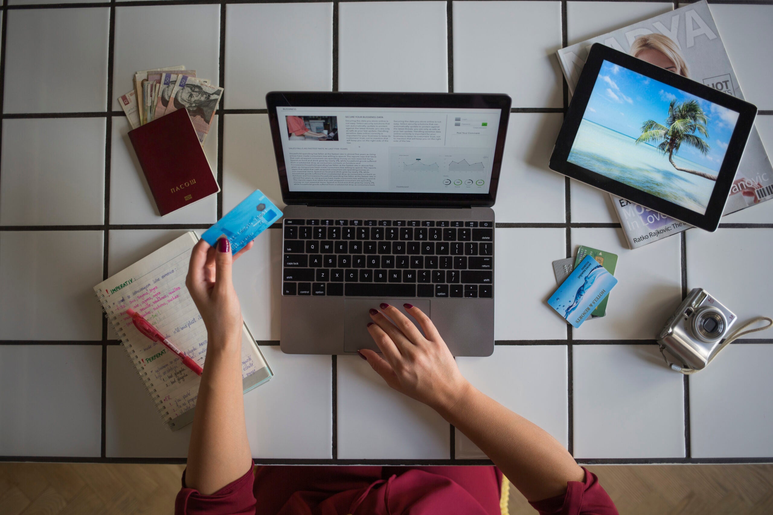 Young woman using laptop, paying with credit card, travel booking